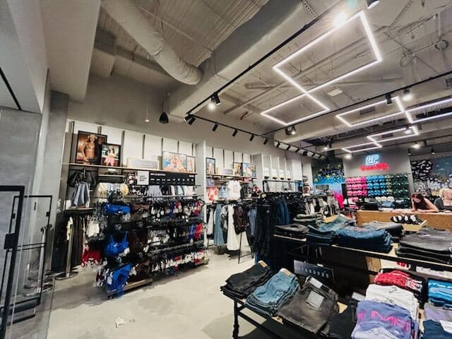 Finished General Pants Co. interior with painted white walls, black exposed ceiling and structural beams by VD Painting
