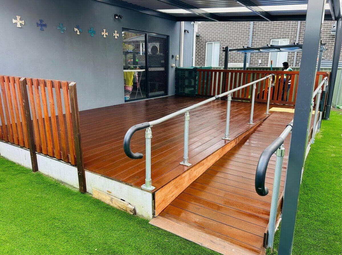 After — freshly stained and sealed timber deck with access ramp under a covered patio in NSW by VD Painting